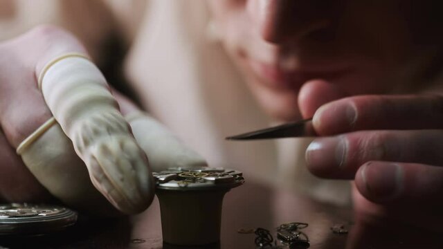 Mechanical watch repair process. Watchmaker adjust watch. Precise occupation. High accuray level