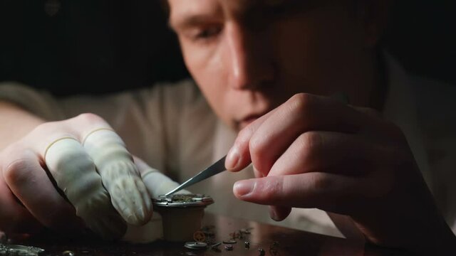 Mechanical watch repair process. Open pocket wristwatch. Watchmaker adjust watch. Precise occupation. High accuray level