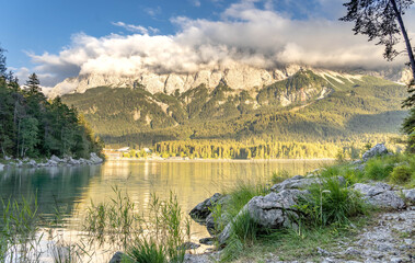 Eibsee lake view of heavy fog Zugspitze in late summer afternoon in Germany