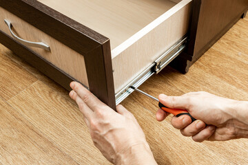 handyman fixing wooden cabinet. furniture repair and assembly conceptual