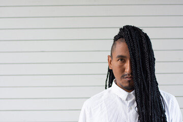 Portrait of a black man with braided hair