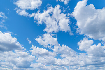 Naklejka na ściany i meble White clouds on the blue sky at day time.