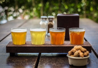 Beer tasting paddle with peanuts on a wooden table