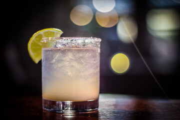 Margarita cocktail drink beverage with lemon slice and bokeh background