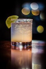 Margarita cocktail drink beverage with lemon slice and bokeh background