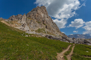 Fototapeta na wymiar Path at the foots of the southern slope of Mount Small Settsass, Dolomites, Italy
