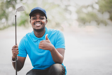 African golfer sitting in golf course