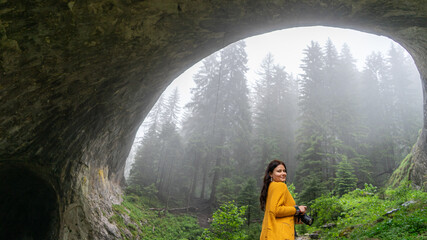Famous Cave in balkans location in Bulgaria National Park. Cute blogger holding camera on a tour...
