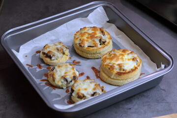 A baking tray with Cheesy Mushroom croustades or Cheesy Mushroom Discs