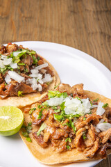 Roast tacos with corn tortillas. Mexican food. Mexican food concept on wooden table. Traditional Mexican food. Mexican tacos.