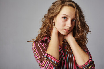 Close up portrait of young beautiful redhead girl looking at camera. Copy the space.