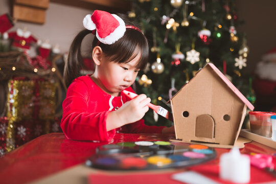 young girl making christmas craft at home