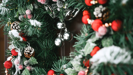 Fototapeta na wymiar Close-up of Christmas wreath with snow on the door. Beautiful decoration.