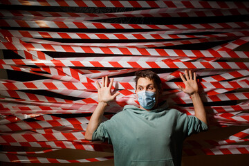 Fence tape and man. Red and white tape for the fence.