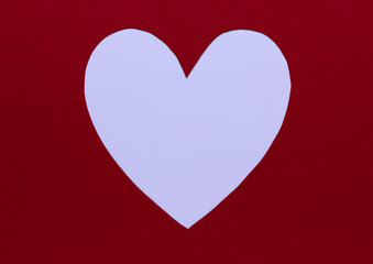 White paper heart on a red background