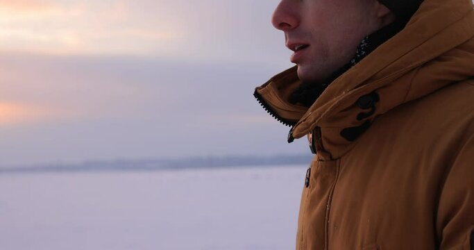 Man breathe with vapour in cold winter, cropped shot of hiker in Arctic nature, slow motion
