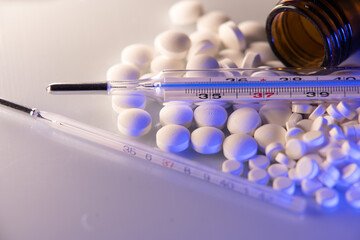 Medicine and Drugs, white Pills with fever thermometer on white background