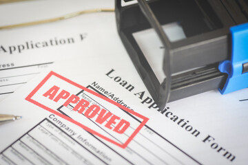Loan application form with Rubber stamping that says Loan Approved, Financial loan money contract agreement company credit or person - loan approval.