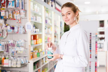 Female pharmacist offering help in choosing at counter in pharmacy. High quality photo