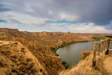 Beautiful landscape with red rocks and lake in the Barrancas de Burujon, Toledo, Spain