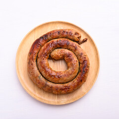 Northern Thai sausage (Sai Aua), Grilled intestine stuffed with minced pork, spices and herbs on white background, popular food in Chiangmai, Thailand