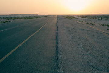 Long straight empty road into the sunset