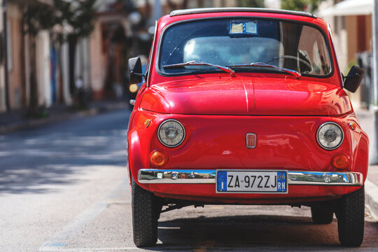 Gabbice Mare, Italy - September 07, 2019. Fiat 500 classic retro car parked at city street road. Iconic vintage car at city center in italian city Gabbice Mare in summer. Close up, front view