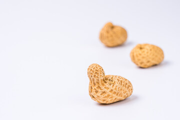 Peanuts with shells on white background