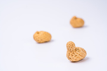 Fototapeta na wymiar Peanuts with shells on white background