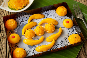 Thong-Eek, Sane Chan and Kanom Jamongkut (Thai sweets) in red box on wooden table