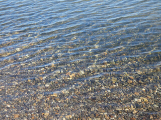 water ripples over rocky lake bottom