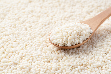 Wooden spoon on top of glutinous rice spread over the entire screen