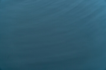 Abstract blurred background of water surface with moving waves.