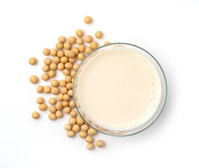 Soy milk and soybeans in a glass on a white background