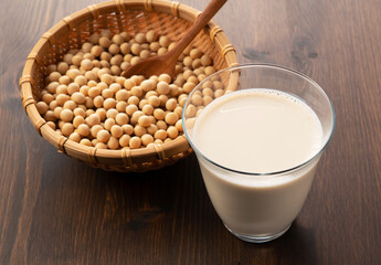 Soy milk in a glass on a wooden background
