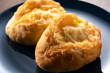 Cheese French bread placed in the background on a wooden table
