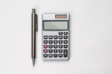 Top view of pen and calculator with white isolated background 