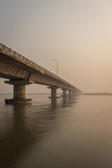 road bridge over river with its water reflection at dawn from low angle