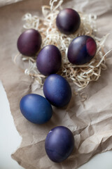 Painted blue and purple Easter eggs on a textured background. Easter eggs on a plate.