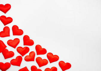 Many textured red hearts on top of each other on a white or gray background: place for text, St. Valentine's Day background, minimalism 