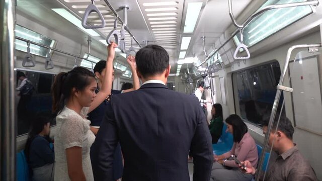 Asian men walking on the subway to work in Bangkok, Thailand 