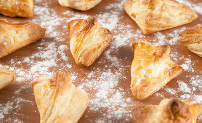 Freshly baked khachapuris with cheese on a wooden table.