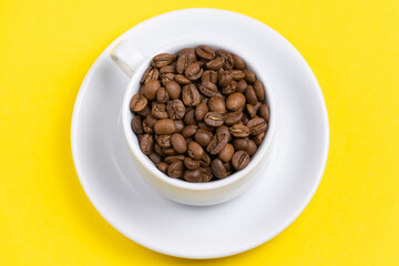 coffee cup with beans on yellow background