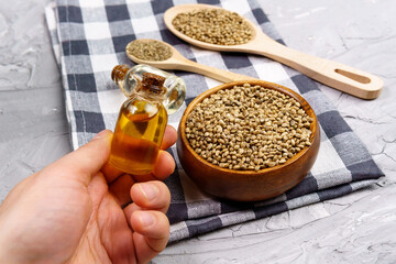Bottles of hemp oil with cannabis seeds. Medical CBD oil. Alternative medicine concept.