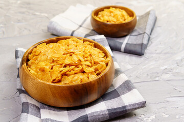 cornflakes in wood bowl. Organic healthy food rich in minerals and vitamins. Eco food for breakfast.