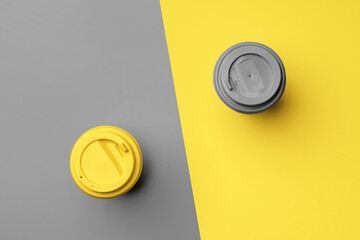 Disposable coffee cup in yellow gray colors