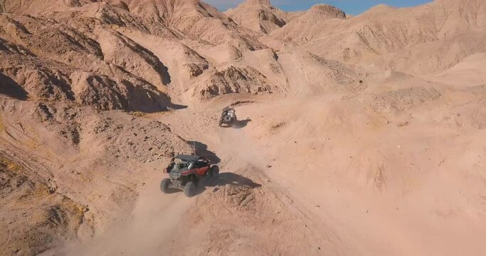 Off-road Vehicles driving through Desert Canyons