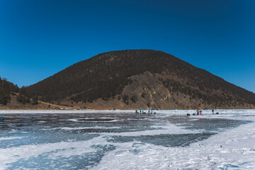 the ice of the frozen lake Baikal in the winter