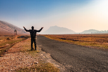 Obraz premium motorcycle rider standing on tarmac road isolated