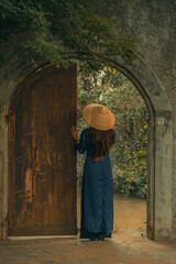 Beautiful Vietnam girl from Hue city, Vietnam who wearing Ao dai. Ao dai is famous traditional custume for woman in Vietnam. Vintage style,travel and relaxing concept.